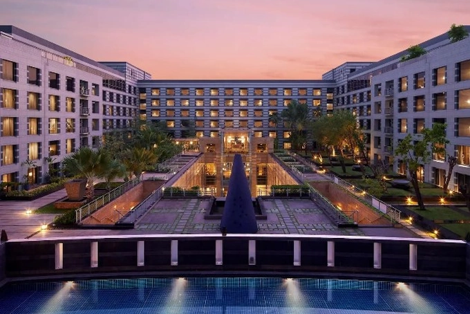 Grand Hyatt Mumbai wedding venue with illuminated pathway and fountains at dusk.