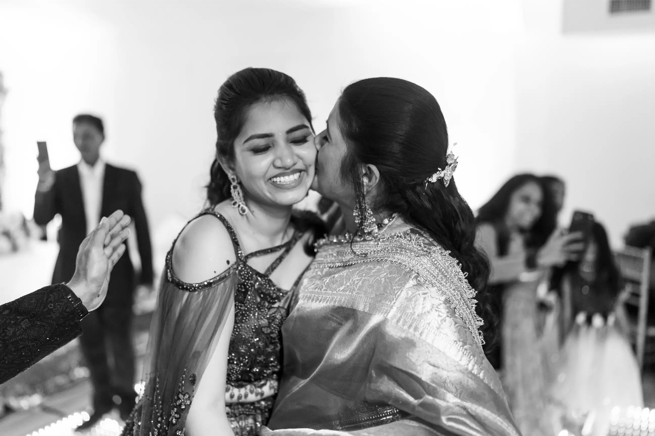 Bride mother was kissing the bride on sangeet.