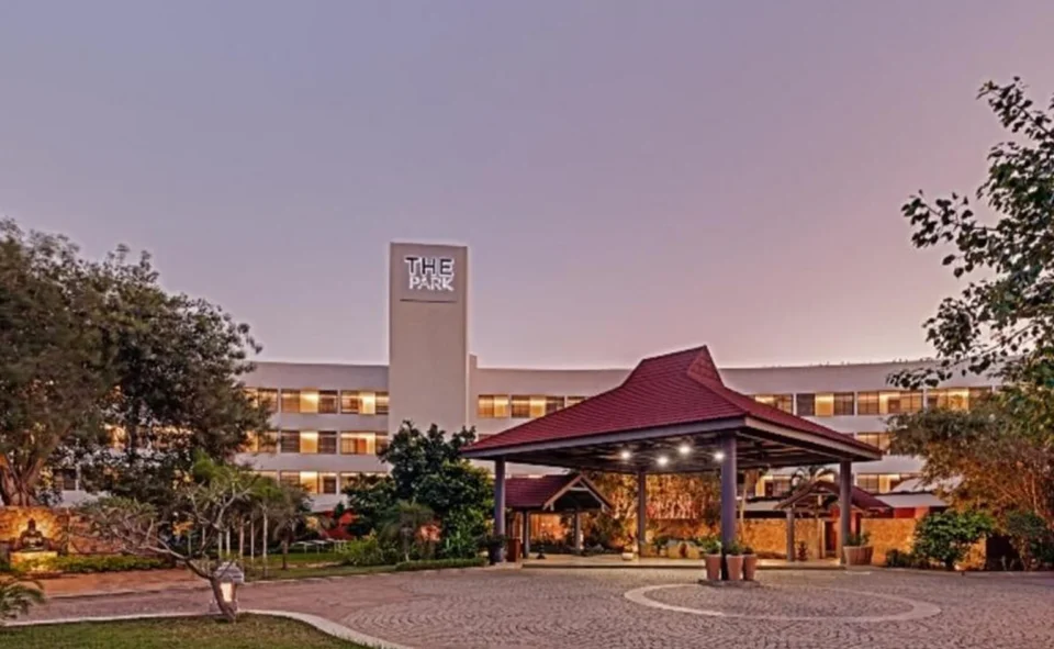 The Park Visakhapatnam hotel entrance at dusk, with a red-roofed pavilion.