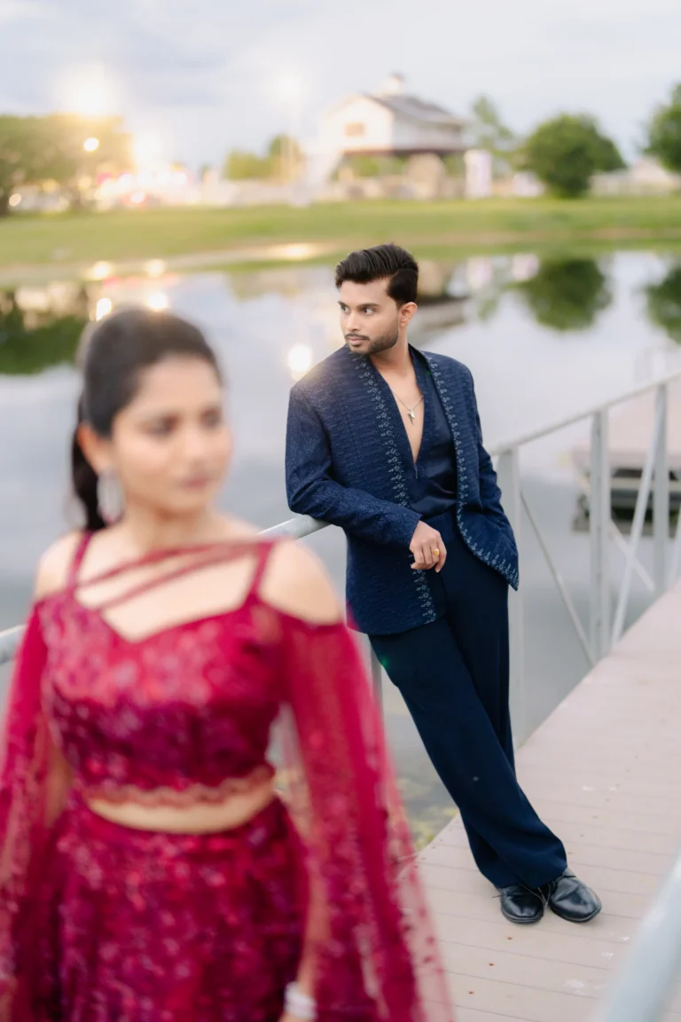 Saikumar & Pavani standing on the bride aside and posing for a picture.