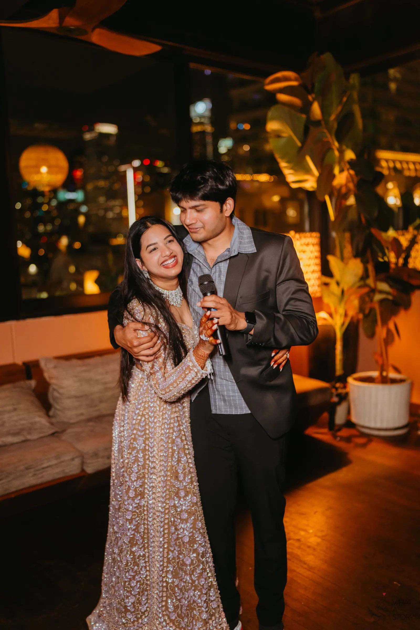 bride holding a microphone together at the cocktail party